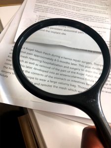 magnifying glass on medical records Palm Beach Legal Nurse